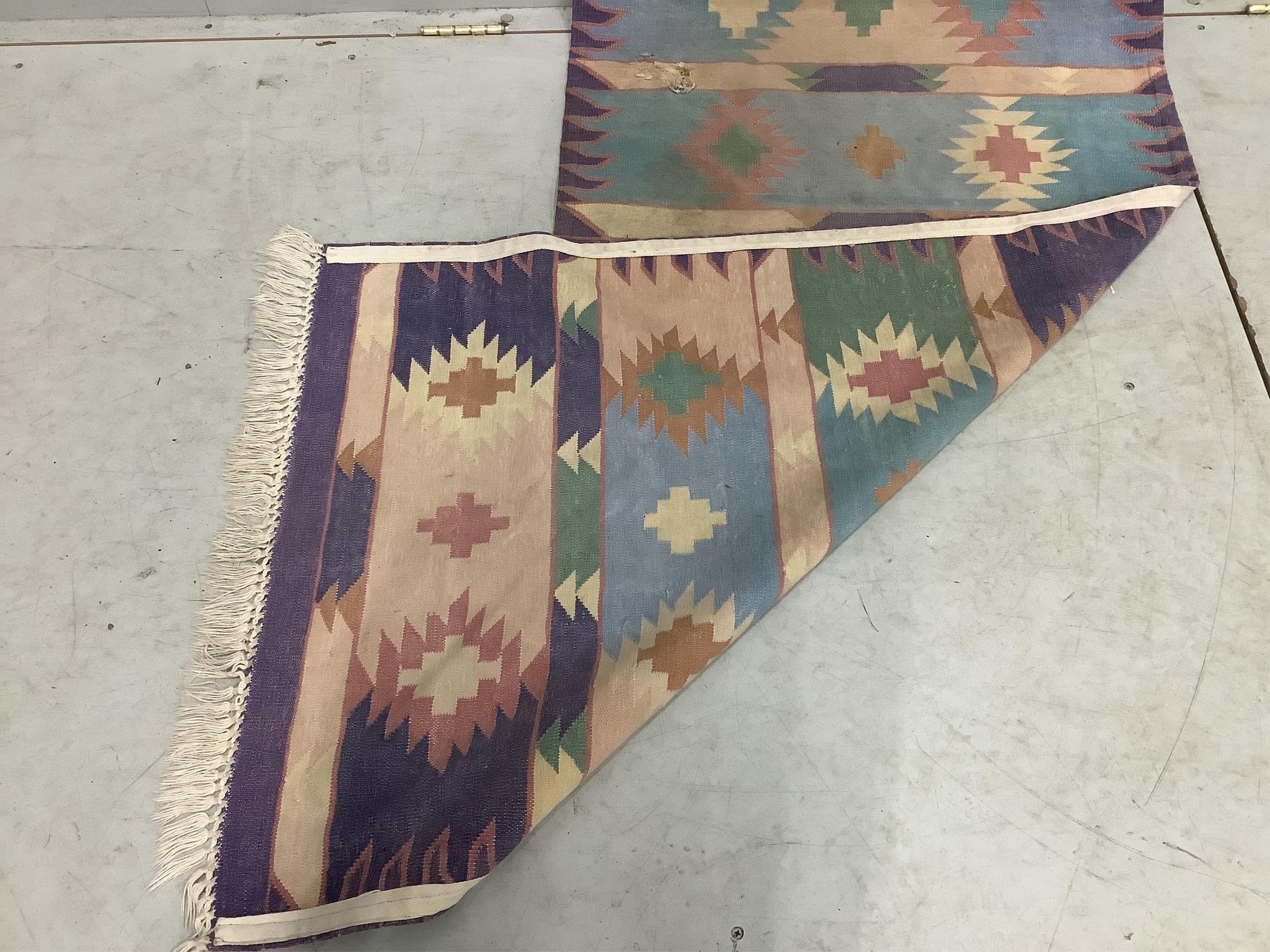 A Kilim flat weave runner, 360cm x 74cm. Condition - poor to fair, holed.